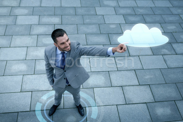 улыбаясь бизнесмен облаке проекция улице бизнеса Сток-фото © dolgachov