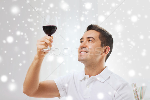 happy man drinking red wine from glass at home Stock photo © dolgachov