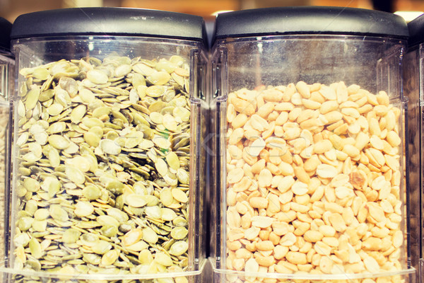 jars of peanuts and pumpkin seeds at grocery store Stock photo © dolgachov