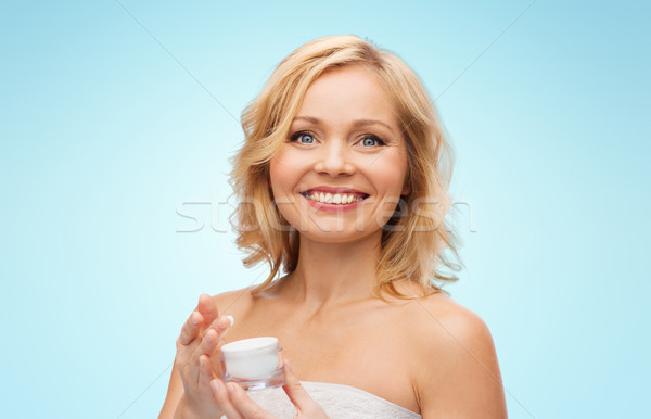 happy middle aged woman with cream jar Stock photo © dolgachov