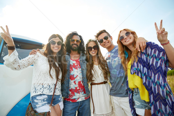 Stock photo: hippie friends over minivan car showing peace sign