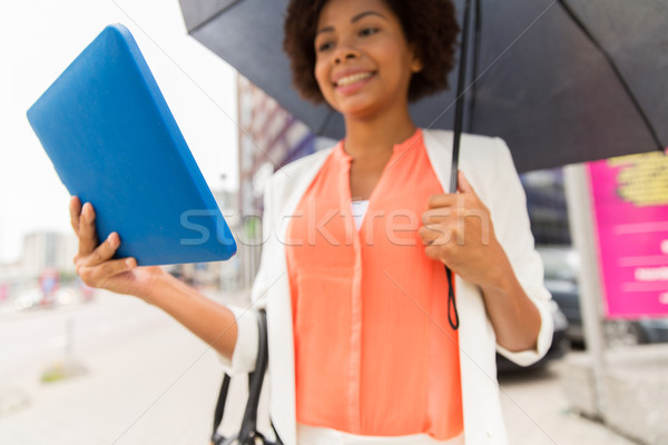 close up of woman with umbrella and tablet pc Stock photo © dolgachov