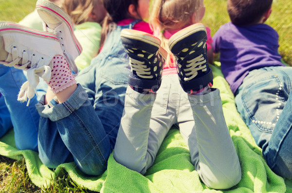 close up of kids lying on picnic blanket outdoors Stock photo © dolgachov