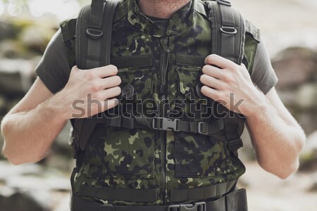 Stock photo: close up of soldier or hunter with gun in forest