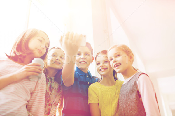 group of school kids with smartphone and soda cans Stock photo © dolgachov