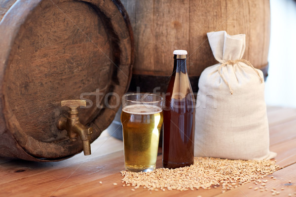 Stock photo: close up of beer barrel, glass, bottle and malt