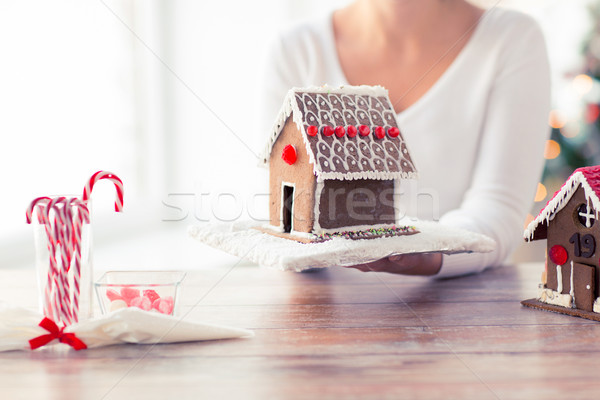 close up of woman showing gingerbread house Stock photo © dolgachov