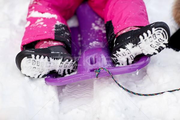 close up of kids feet in winter boots on sled Stock photo © dolgachov