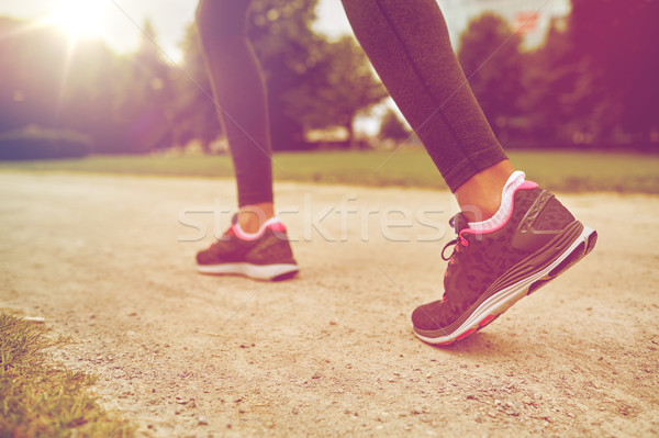 close up of woman feet running on track from back Stock photo © dolgachov