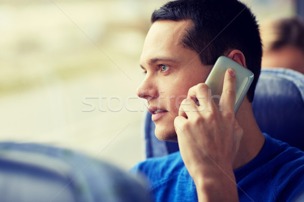 happy man in travel bus and calling on smartphone Stock photo © dolgachov