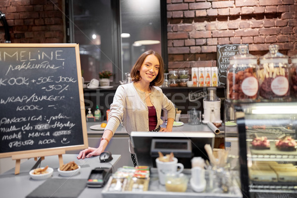 happy woman or barmaid at cafe counter Stock photo © dolgachov