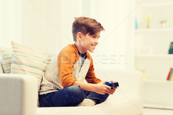Vidám fiú botkormány játszik videojáték otthon szabadidő Stock fotó © dolgachov