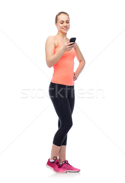 happy smiling sportive young woman with smartphone Stock photo © dolgachov