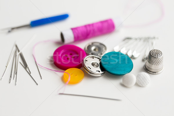 sewing buttons, needles, pins and thread spool Stock photo © dolgachov