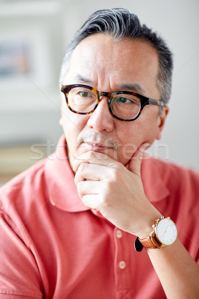Asian człowiek myślenia domu ludzi okulary Zdjęcia stock © dolgachov