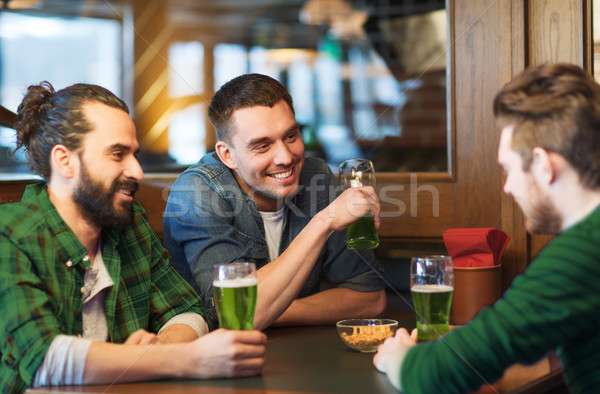 male friends drinking green beer at bar or pub Stock photo © dolgachov