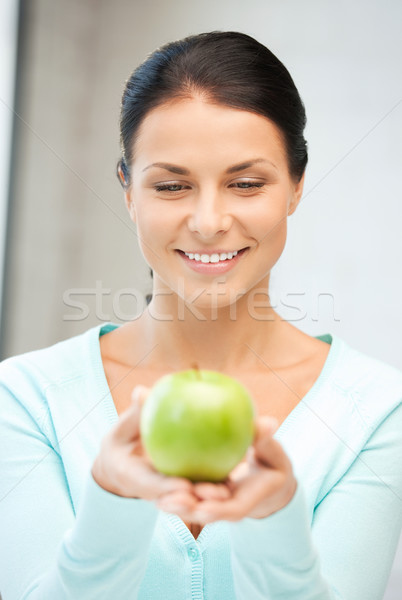 lovely housewife with green apple Stock photo © dolgachov