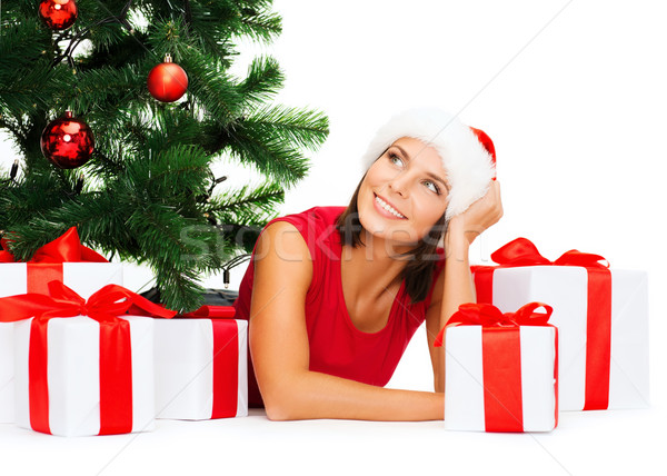 Stock photo: smiling woman in santa helper hat with gift boxes
