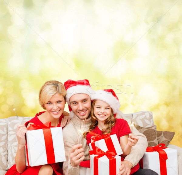 smiling family holding gift boxes and sparkles Stock photo © dolgachov