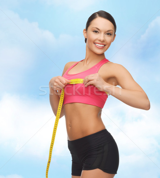 sporty woman measuring her breast Stock photo © dolgachov