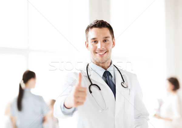 doctor with stethoscope showing thumbs up Stock photo © dolgachov