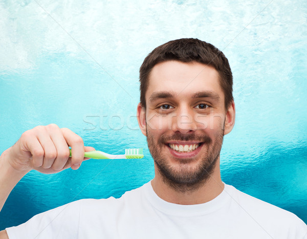 Glimlachend jonge man tandenborstel gezondheid schoonheid water Stockfoto © dolgachov