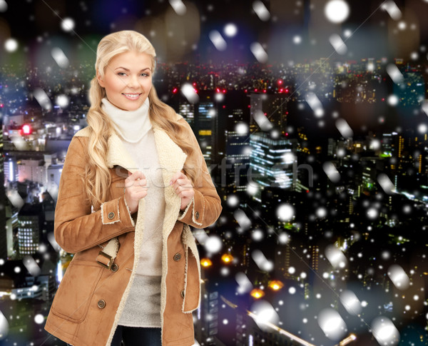 smiling young woman in winter clothes Stock photo © dolgachov