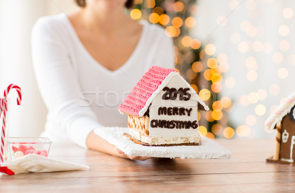 close up of woman showing gingerbread house Stock photo © dolgachov