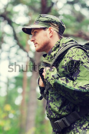 young soldier or hunter with knife in forest Stock photo © dolgachov
