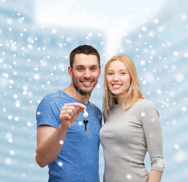 smiling couple holding keys Stock photo © dolgachov
