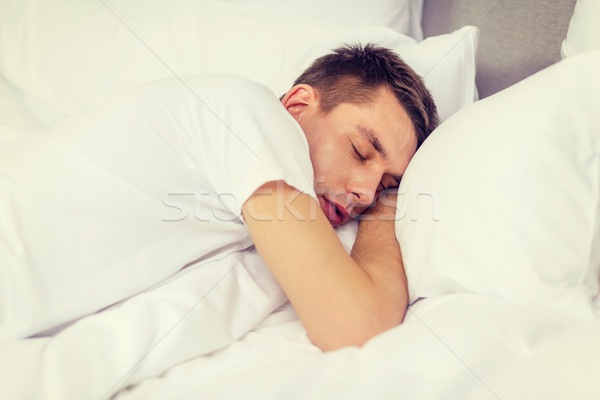Bel homme dormir lit hôtel Voyage bonheur [[stock_photo]] © dolgachov