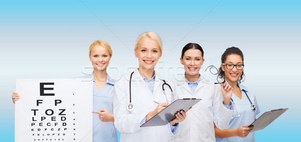 smiling female eye doctors and nurses Stock photo © dolgachov
