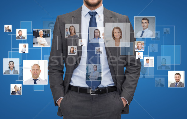 close up of businessman over icons with contacts Stock photo © dolgachov