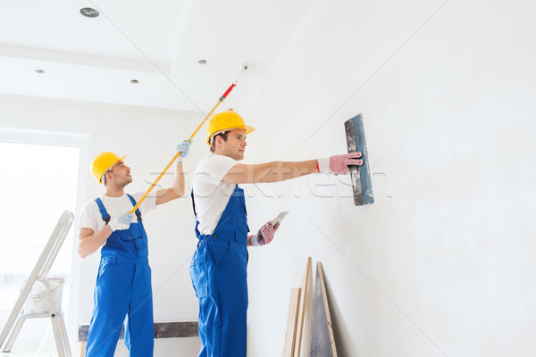 group of builders with tools indoors Stock photo © dolgachov