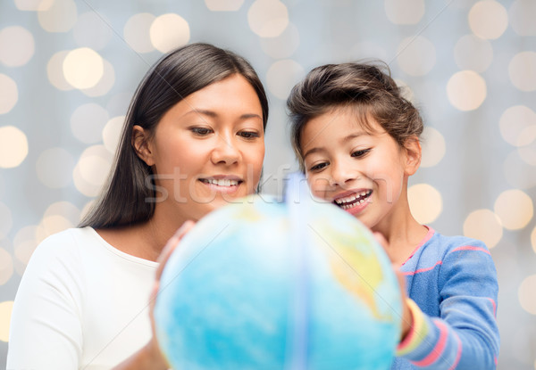 mother and daughter with globe Stock photo © dolgachov