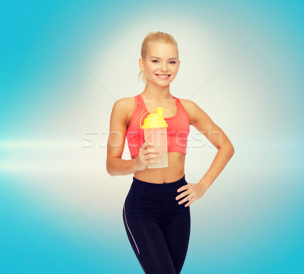 Uśmiechnięty kobieta białko shake butelki Zdjęcia stock © dolgachov