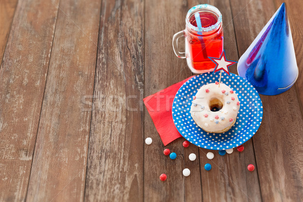 donut with juice and candies on independence day Stock photo © dolgachov