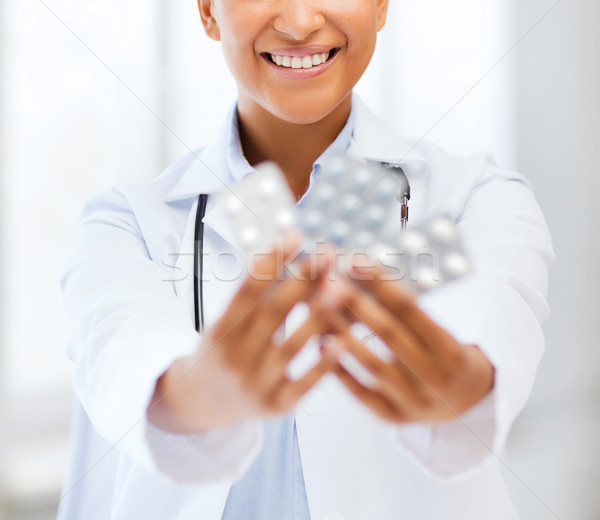 doctor with blister packs of pills Stock photo © dolgachov