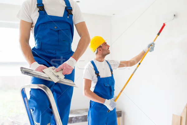 two builders with painting tools repairing room Stock photo © dolgachov