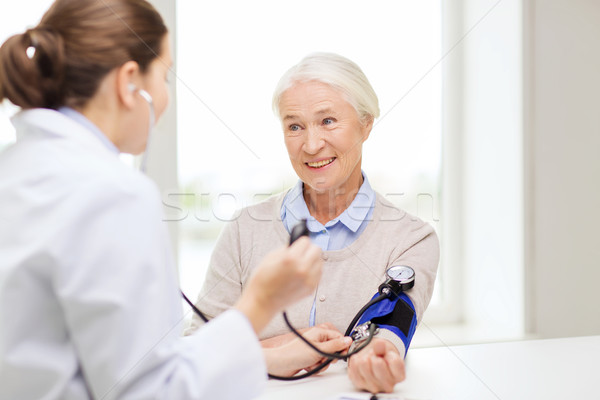 Stock photo: doctor with tonometer and senior woman at hospital
