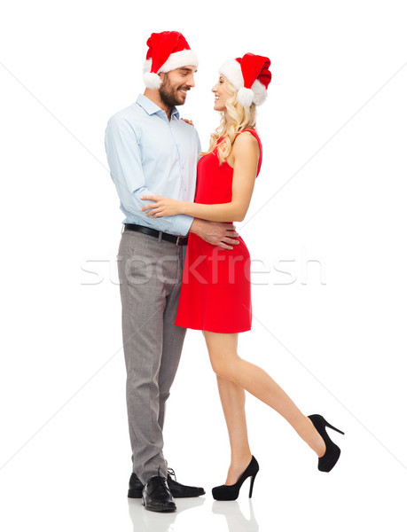 happy couple in santa hats hugging Stock photo © dolgachov