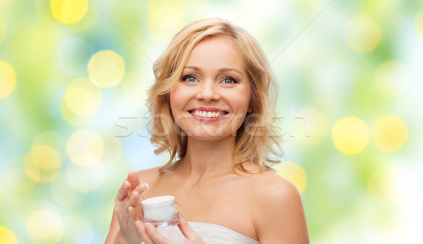 happy middle aged woman with cream jar Stock photo © dolgachov