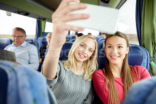 women taking selfie by smartphone in travel bus Stock photo © dolgachov