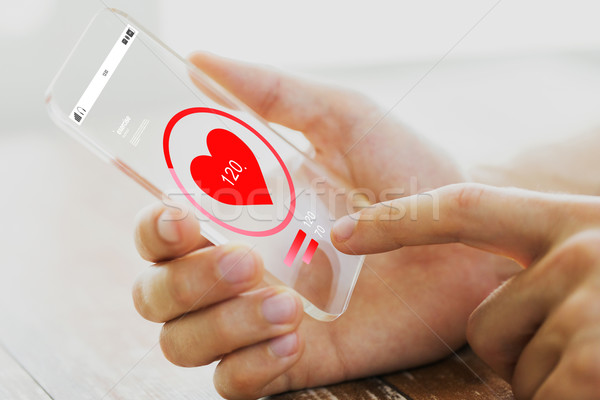 close up of hand with heart rate on smartphone Stock photo © dolgachov