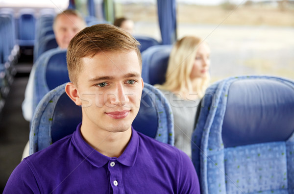happy young man sitting in travel bus or train Stock photo © dolgachov