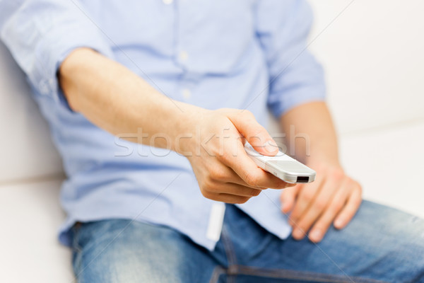 close up of man with tv remote control at home Stock photo © dolgachov