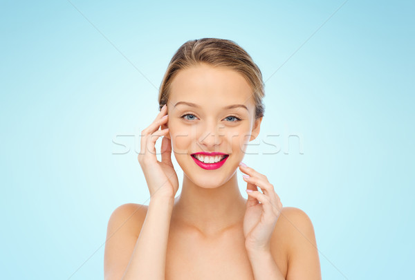 smiling young woman with pink lipstick on lips Stock photo © dolgachov