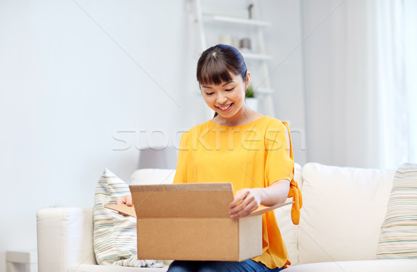 happy asian young woman with parcel box at home Stock photo © dolgachov