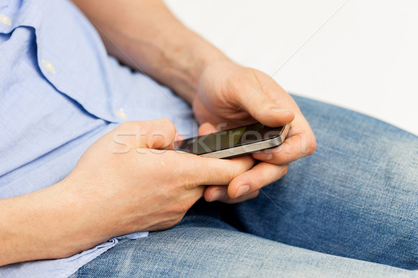 close up of man with smartphone at home Stock photo © dolgachov