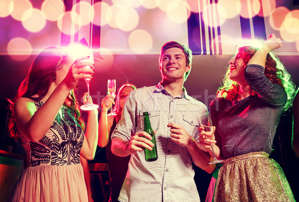 Souriant amis verres à vin bière club fête [[stock_photo]] © dolgachov